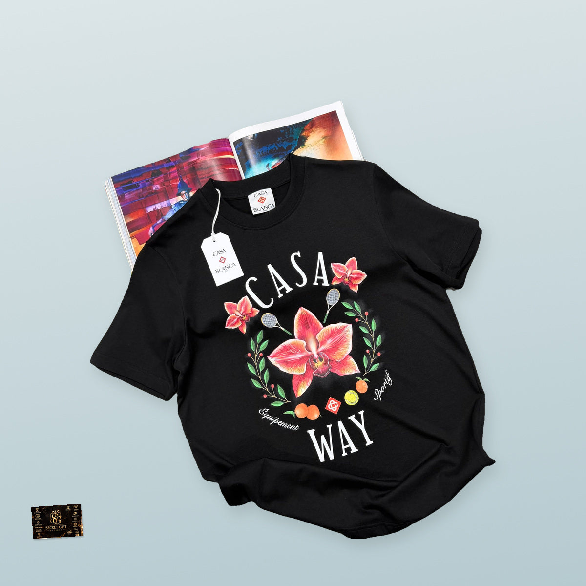 CB CASA WAY T SHIRT - BLACK with a realistically scaled Secret Gift Society marble business card