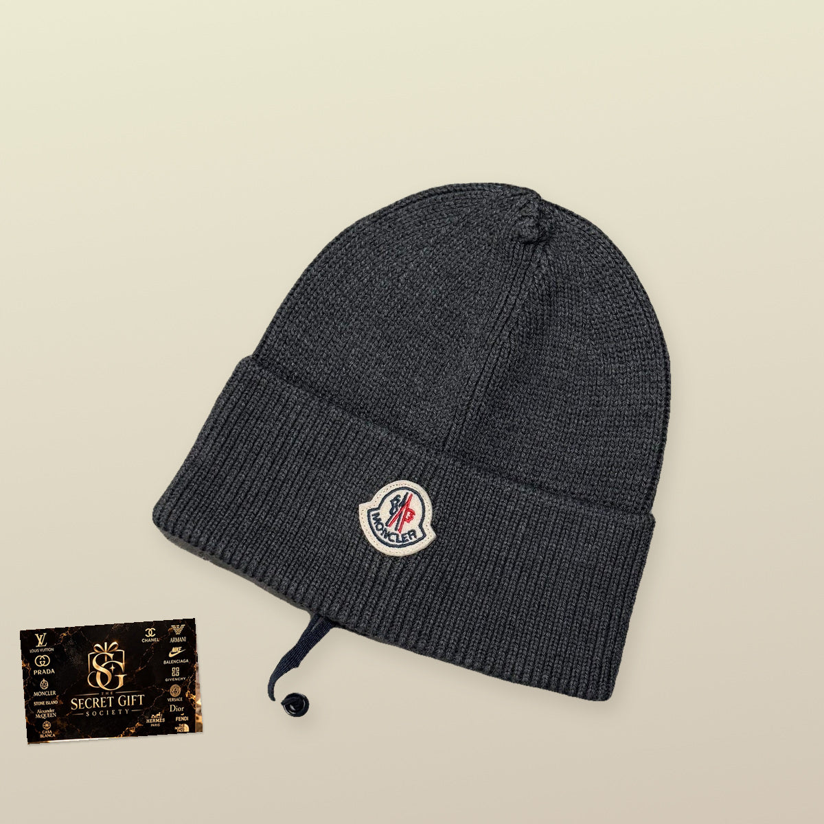MNCLR BEANIE - CHARCOAL with a realistically scaled Secret Gift Society marble business card