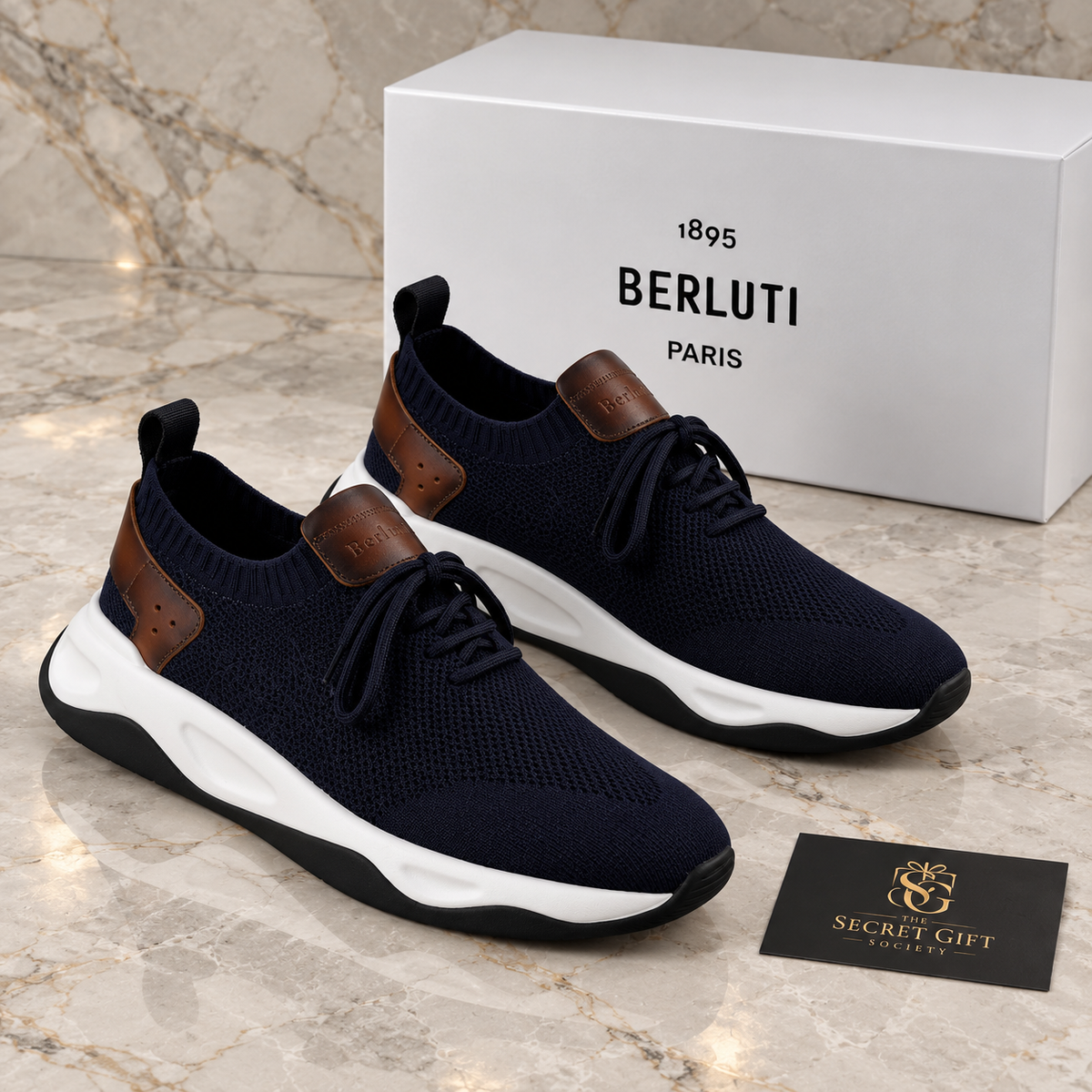 BRLT SHADOW TRAINER - NAVY with its branded box on polished marble and a Secret Gift Society business card