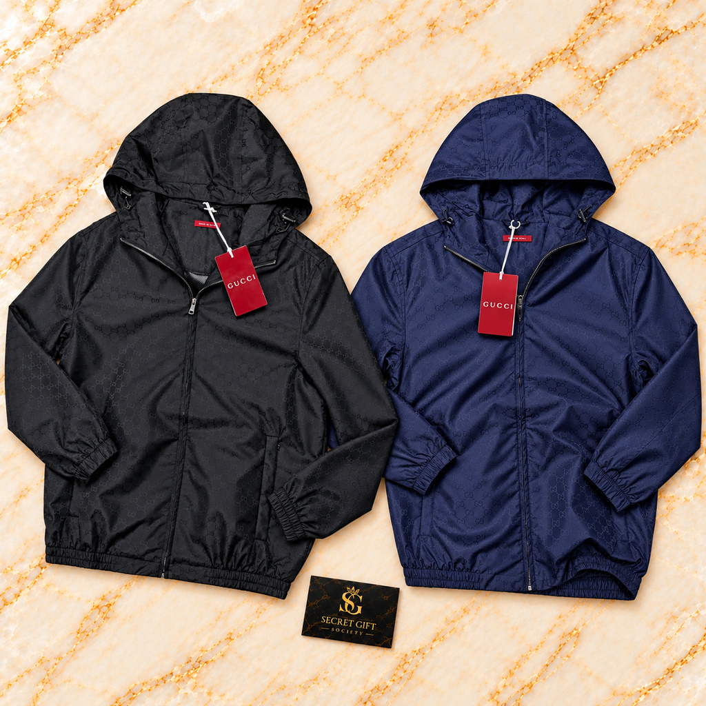 Gucci REPEAT LOGO WINDBREAKER — Black, Navy colour collage. Choose a colour and size; one garment per order. Secret Gift Society card is a styling prop.