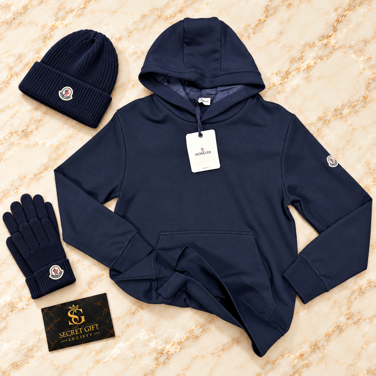 MNCLR ADJUSTABLE HOODIE - NAVY on ivory marble with matching branded beanie and gloves and Secret Gift Society business card