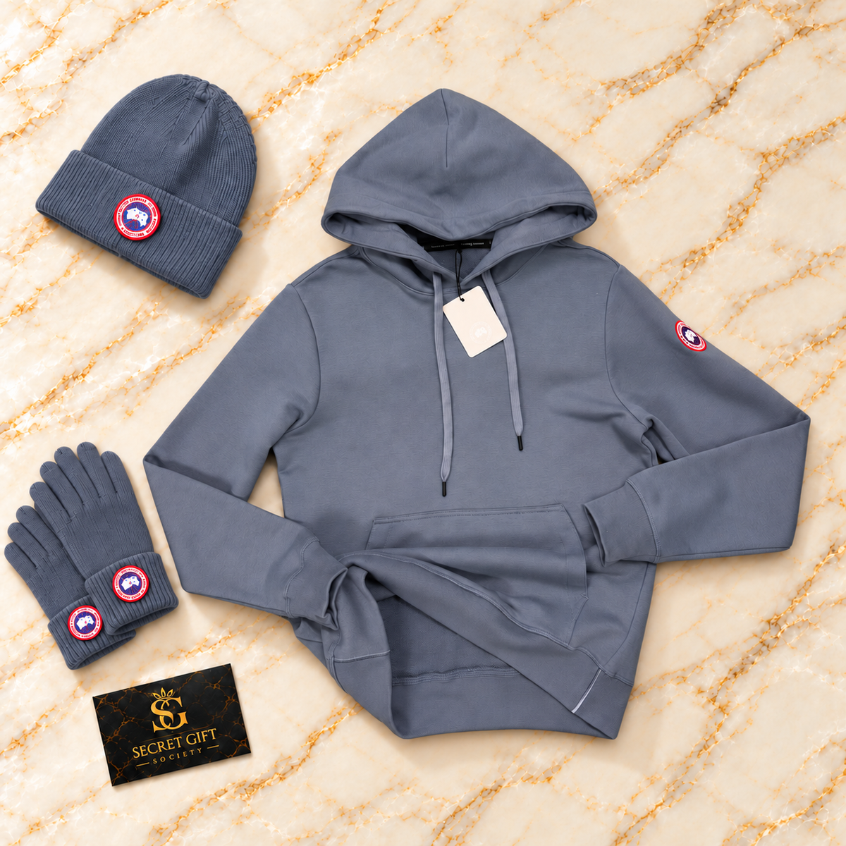 CG LOGO HOODIE - PALE BLUE with matching branded styling props and Secret Gift Society card