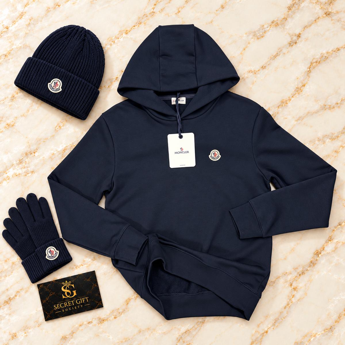 MNCLR LOGO HOODIE - NAVY on ivory marble with matching branded beanie and gloves and Secret Gift Society business card
