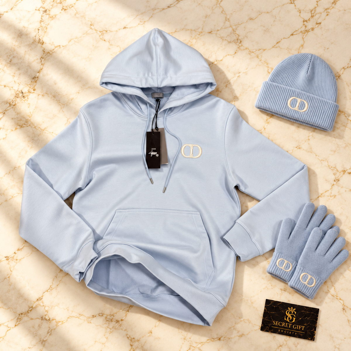 CD HOODIE - SKY BLUE on ivory marble with matching branded beanie and gloves and Secret Gift Society business card