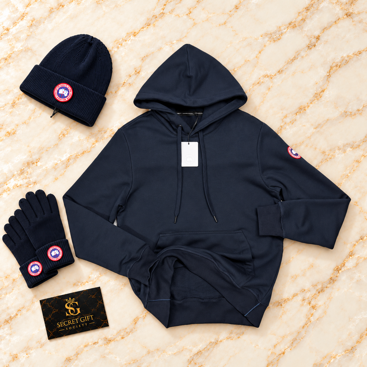 Navy CG logo hoodie with matching branded styling props and Secret Gift Society card