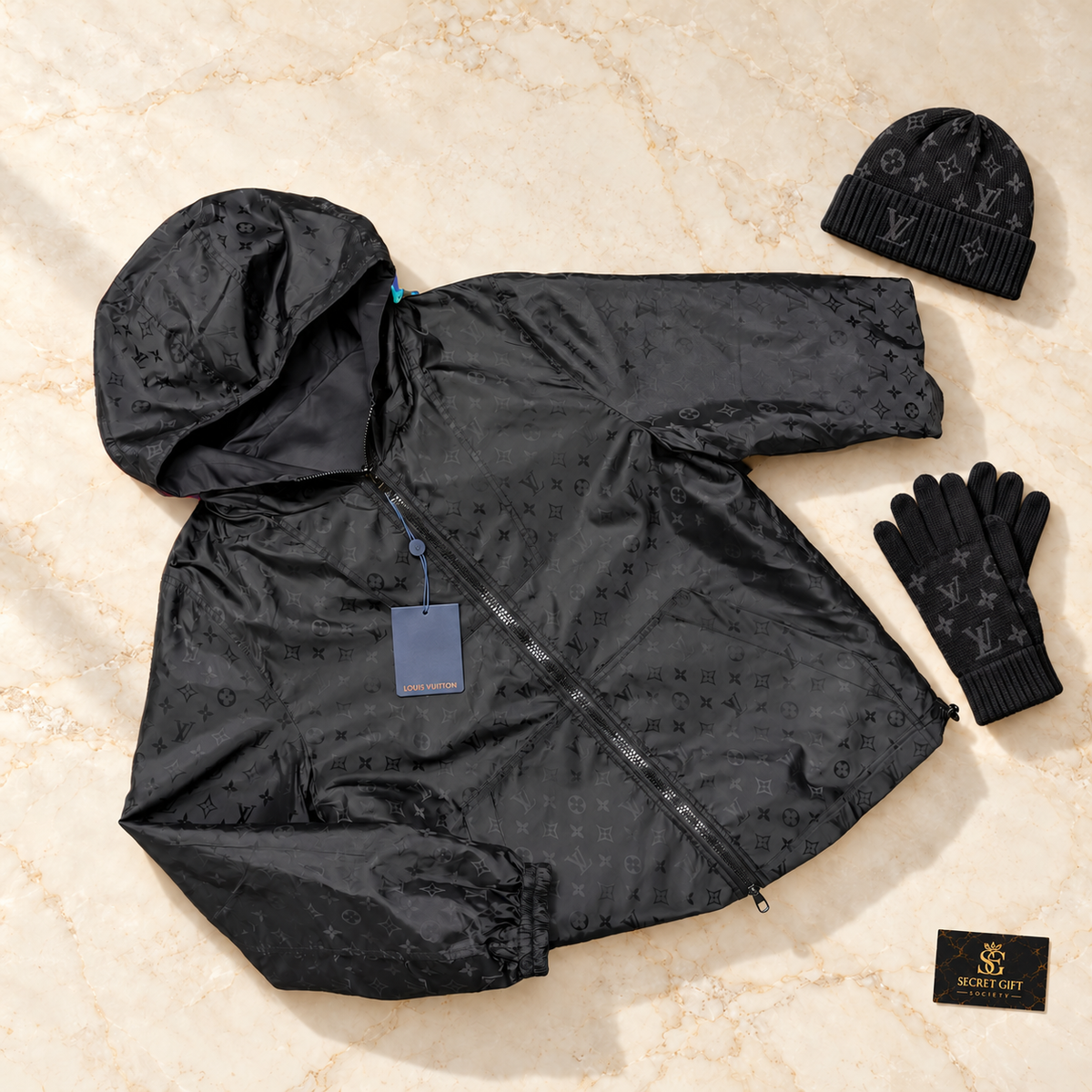 LVE REVERSIBLE MONOGRAM JACKET - BLACK styled on ivory marble with matching-brand hat and gloves and Secret Gift Society card