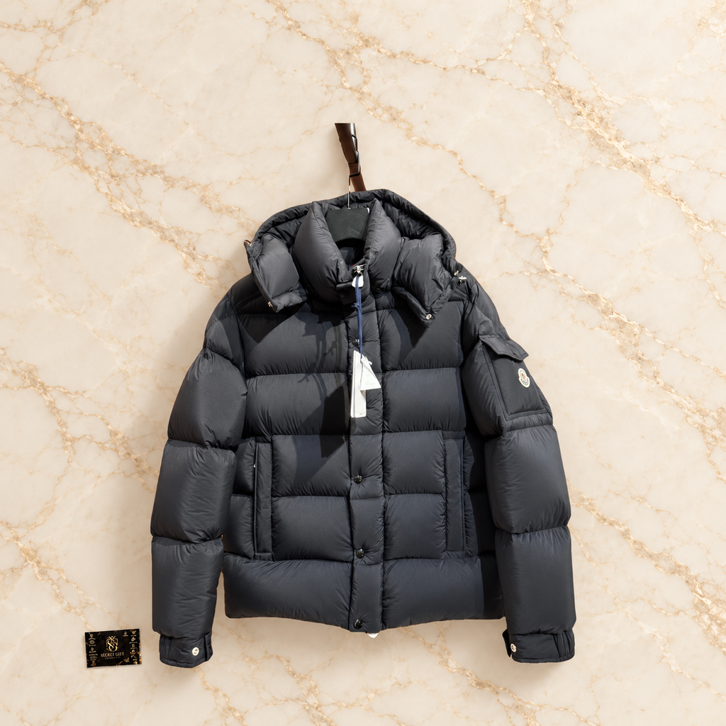 MNCLR MAYA 70 COAT - BLACK on ivory marble with Secret Gift Society card