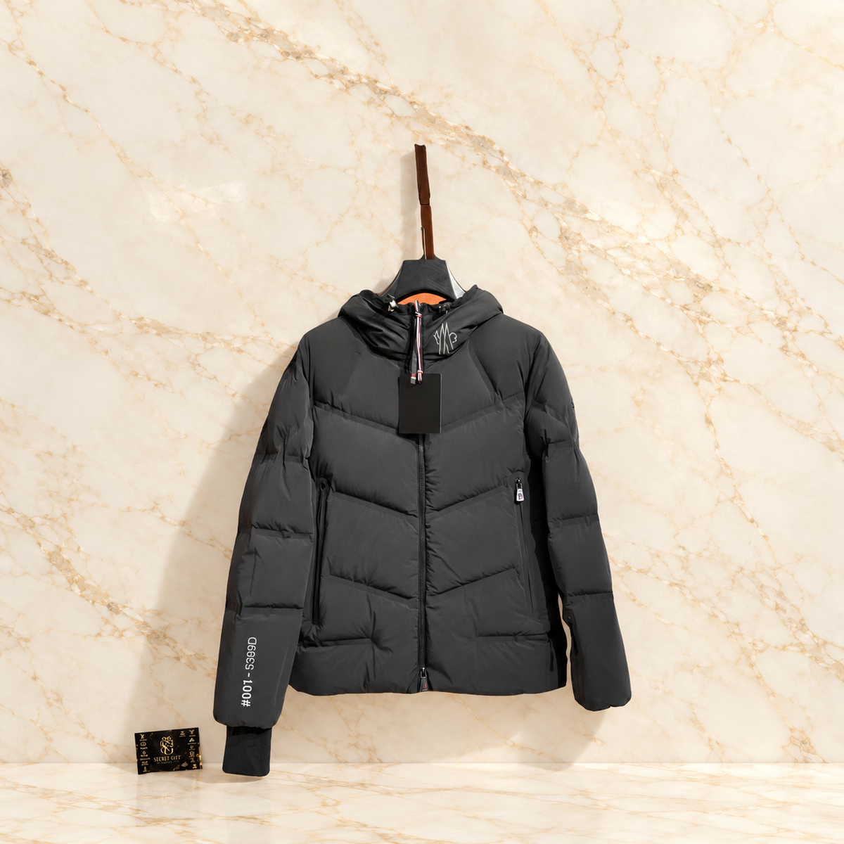 MNCLR REFLECTIVE GRENOBLE COAT - BLACK on ivory marble with Secret Gift Society card