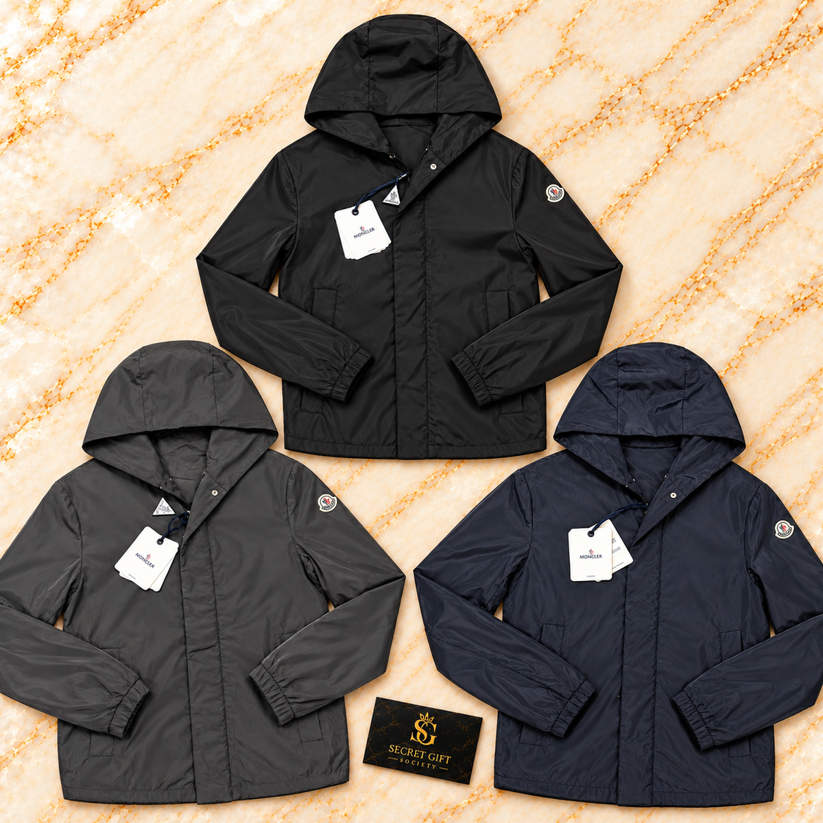 Moncler GRANDANS JACKET — Black, Anthracite, Navy colour collage. Choose a colour and size; one garment per order. Secret Gift Society card is a styling prop.